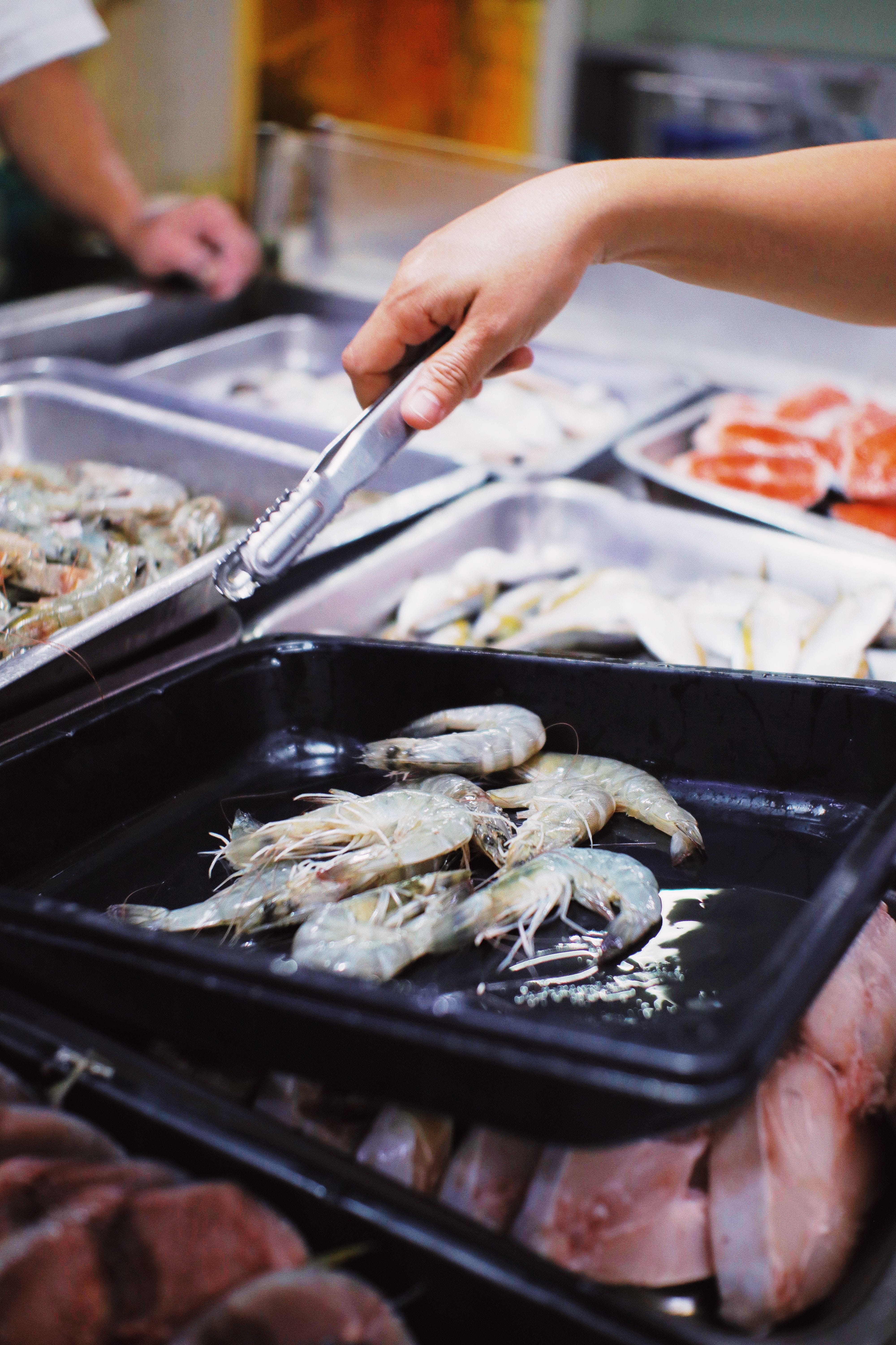 Fresh and frozen seafood displayed in a modern retail market